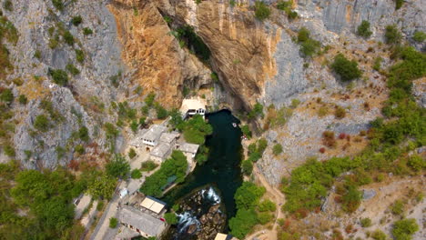 drone view of blagaj with tekija on the base cliffs along buna river in bosnia and herzegovina