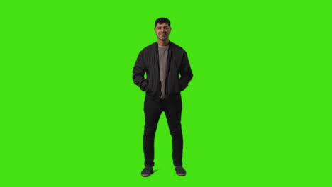 Full-Length-Shot-Of-Smiling-Casually-Dressed-Young-Man-Standing-Against-Green-Screen-With-Hands-In-Pockets-2