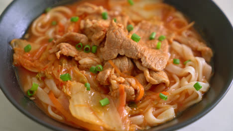 korean udon ramen noodles with pork in kimchi soup - asian food style