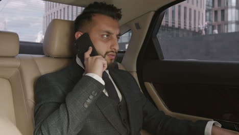 businessman talking on phone and leaving car