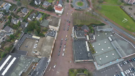aerial of small street in typical dutch town leading to a busy roundabout