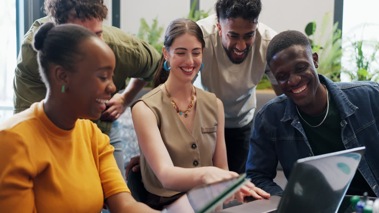 Diverse Group of Young Professionals Collaborating and Laughing in Modern Office