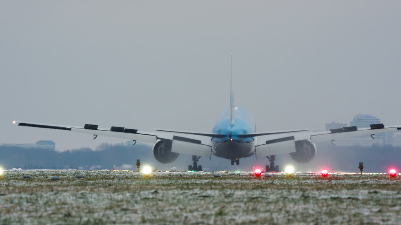 Large Passenger Airplane Landing on Snowy Runway in Winter