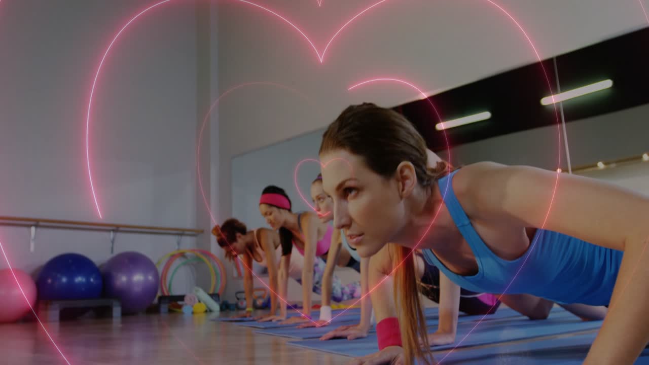 Front woman holding plank, classmates moving in sync for fitness, neon heart pulsing, framing group