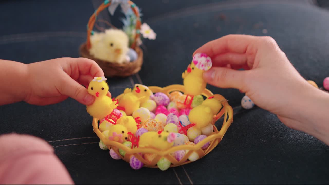 Child and Adult Hands Decorating Easter Basket with Chicks and Eggs