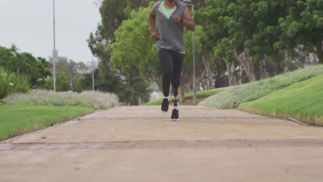 front view man with prosthetic leg running