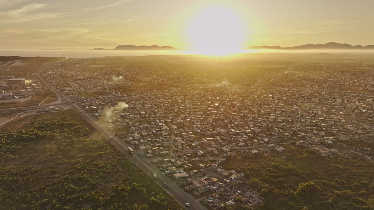 Cape Town South Africa Aerial v101 flyover Baden Powell Dr capturing densely populated Khayelitsha township in sunset's golden glow - Shot with Mavic 3 Pro Cine - Jan 11th 2024