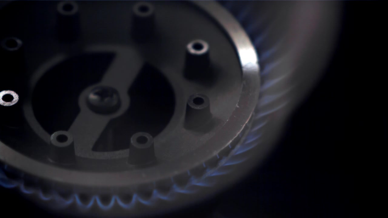 Close-up of Blue Gas Flame Igniting on Stove Burner