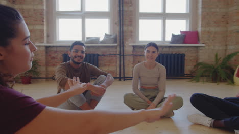 multiethnic dance team chatting in studio