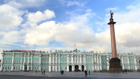 people are walking near the hermitage in st-petersburg