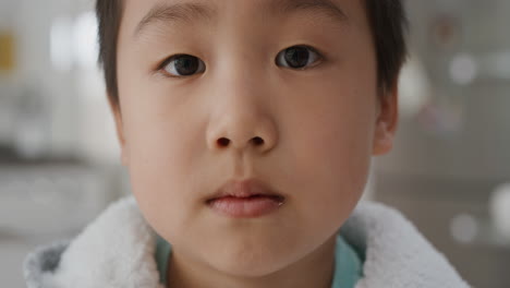 portrait of adorable little asian boy looking at camera childhood testimonial 4k footage