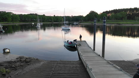 Low-Flying-Tracking-Drone-footage-of-fishermen-preparing-to-launch-at-Saco-Bay,-Maine