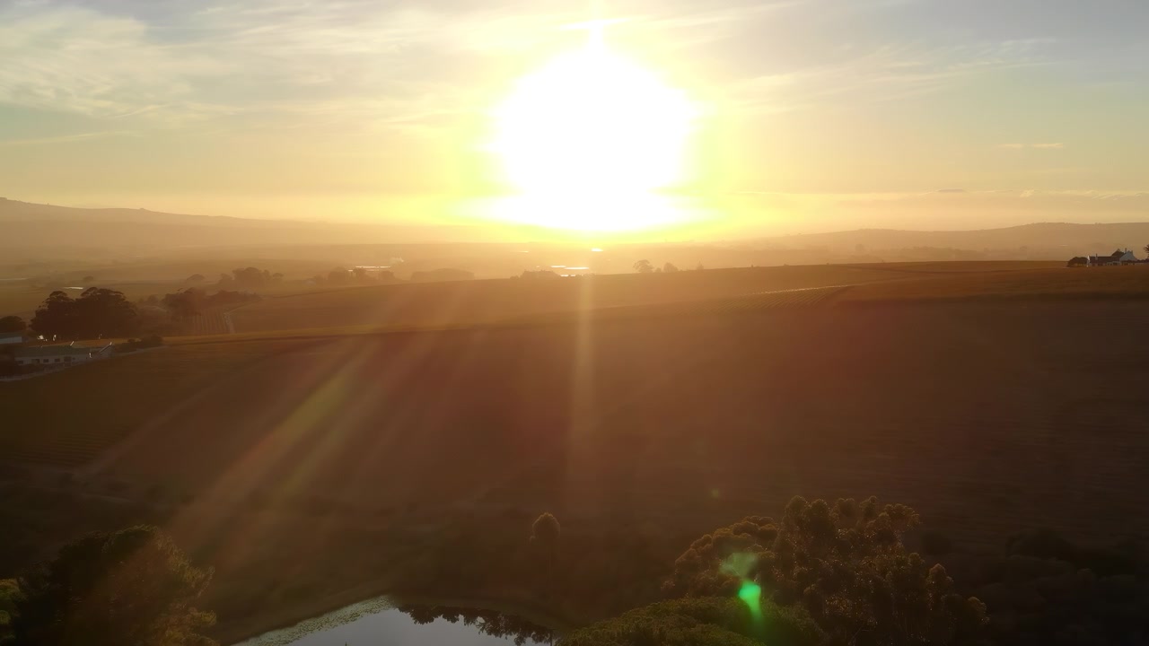 Aerial Drone View Winding Stream Golden Moorland, Rolling Hills Under Clear Blue Sky, Sparse Vegetation