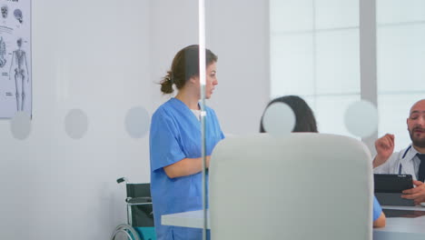 nurse talking in front of teamworkers about treatment development