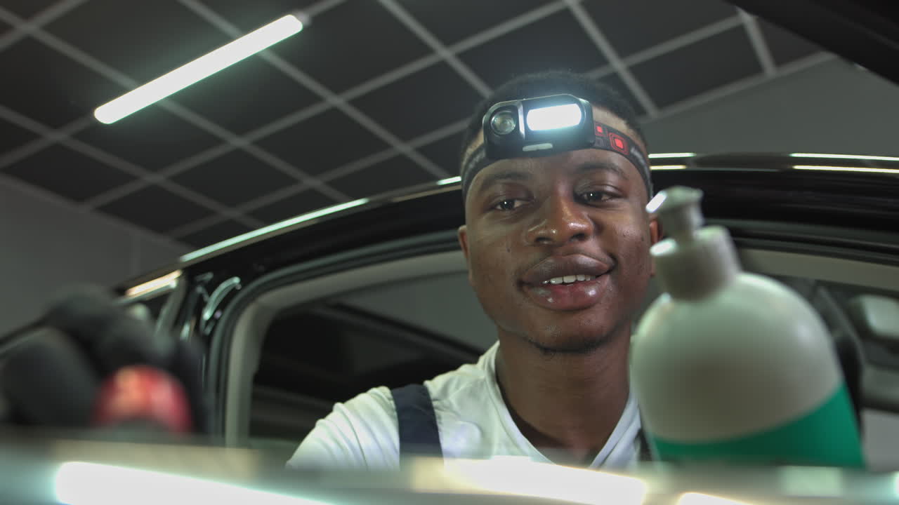 Car repair service by smiling mechanic