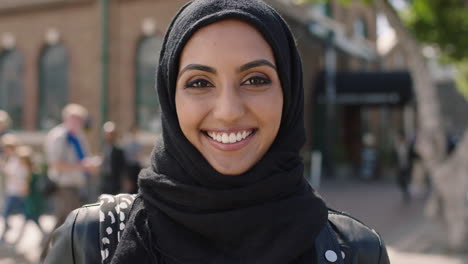 portrait of young beautiful muslim woman smiling enjoying urban lifestyle