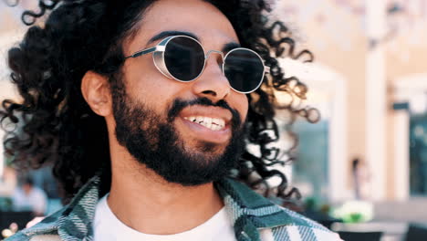 happy man with curly hair and sunglasses