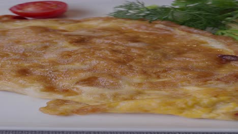 delicious omelette with fresh herbs and tomatoes