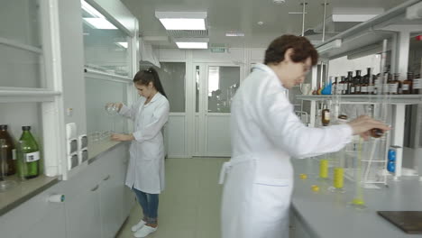 scientist in labcoat doing experiments in lab