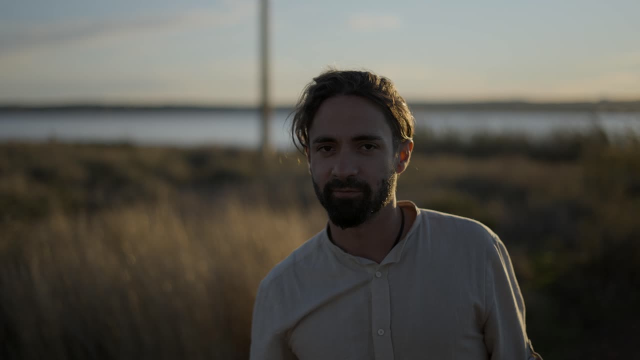 Man Walking with Guitar at Sunset
