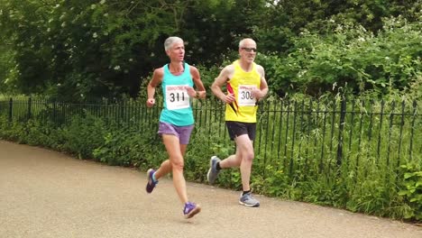 slow motion of runners in race at kensington gardens, which occurs regularly on saturday mornings.