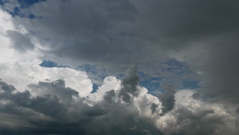 dark moody clouds rolling over skyscape, static time lapse view