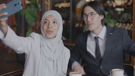 business colleagues taking a selfie in a cafe