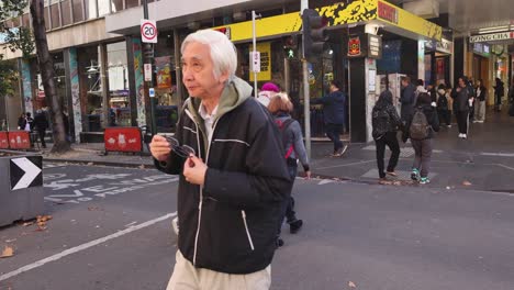 pedestrians crossing street in melbourne, may 2024