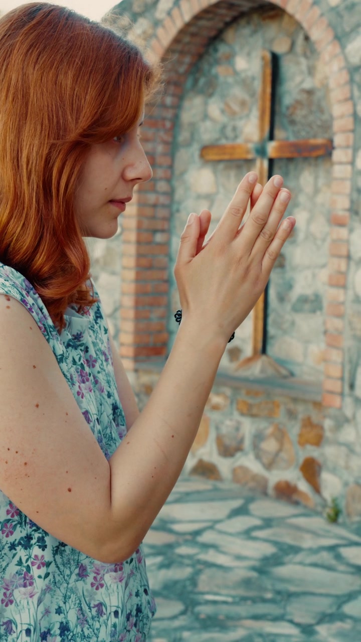 An Italian woman prays for forgiveness before a Christian crucifix at calvary