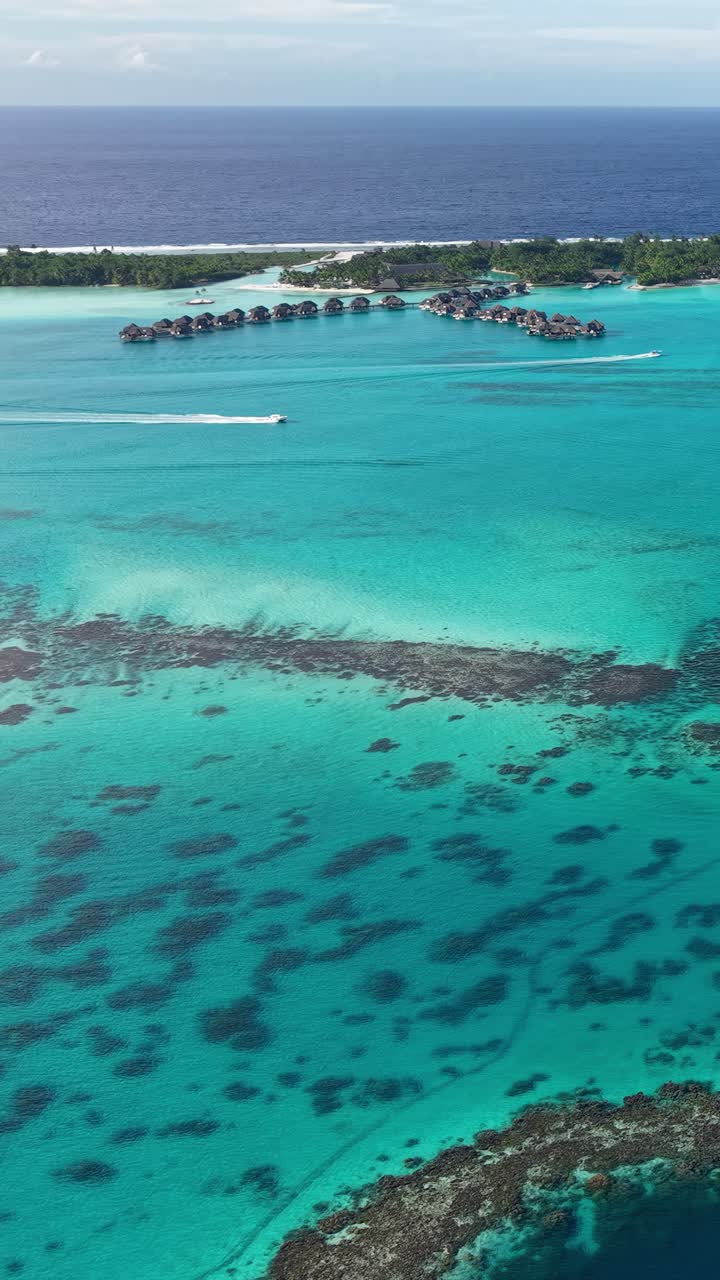 Bora Bora Island, French Polynesia. Vertical Drone Shot of Lagoon and Luxury Bungalows Over Water