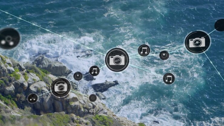 Animation of network of digital icons against aerial view of sea waves hitting the rocks