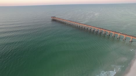 drone flying over a path of sea oats and emerald waters white sands of the gulf of mexico at sunrise summer day