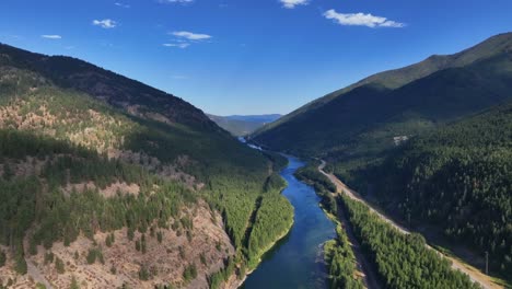 dramatic landscape of lush forest mountains in flathead river near glacier national park in montana, usa