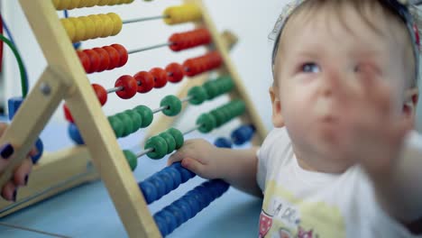 child plays with a multi-colored toy 4