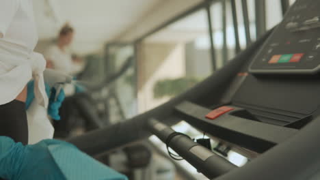 disinfecting and cleaning exercise machines in the gym 1