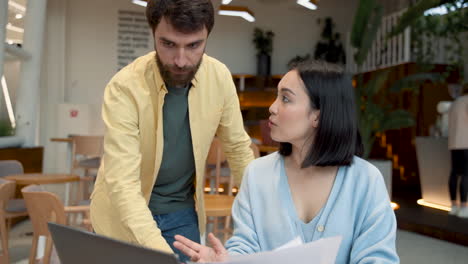 an business woman tells work stuff to a colleague at a meeting in the cafeteria