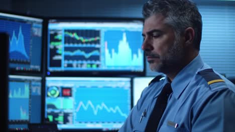 focused analyst interpreting complex data trends in a high-tech monitoring room, analyzing charts and making critical decisions from multiple screens