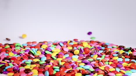 hands interacting with colorful candies on table