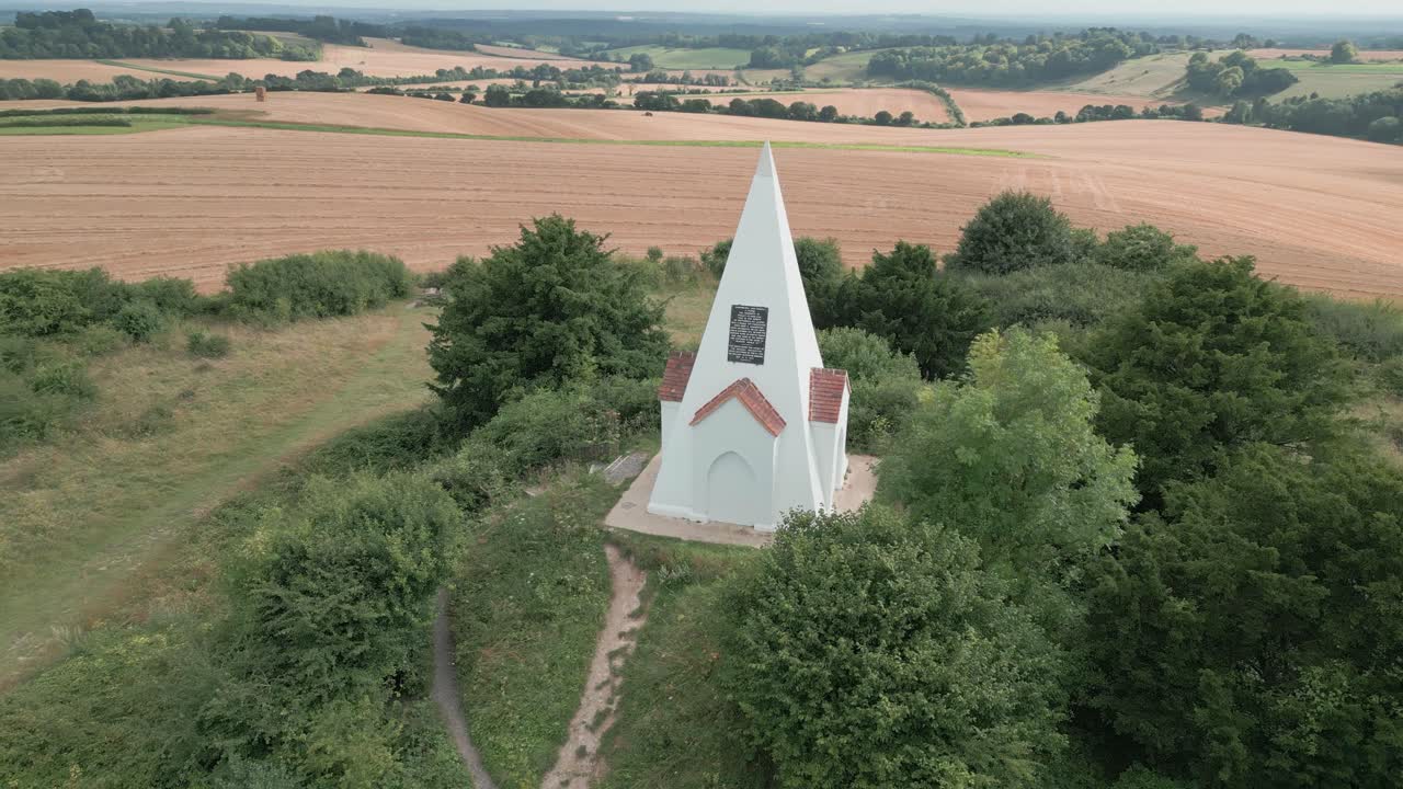 Aerial view orbiting Farley mount monument horse burial marker on Hampshire country park hill