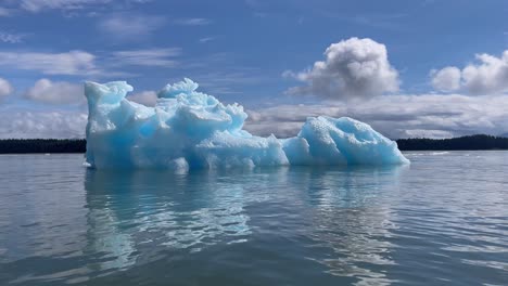 excellent footage of an iceberg in laconte bay with a cloudy sky