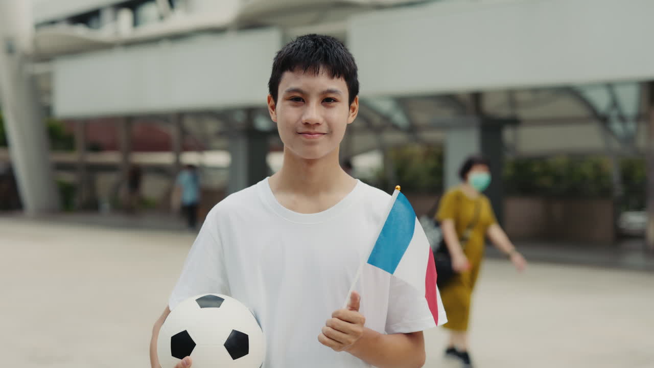 Teenager with football and French flag