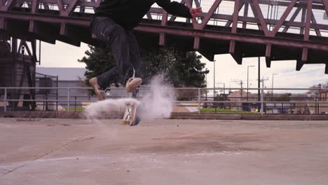 skateboarder in super slow motion 360 flip with powder