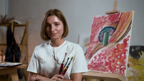 woman posing with brushes