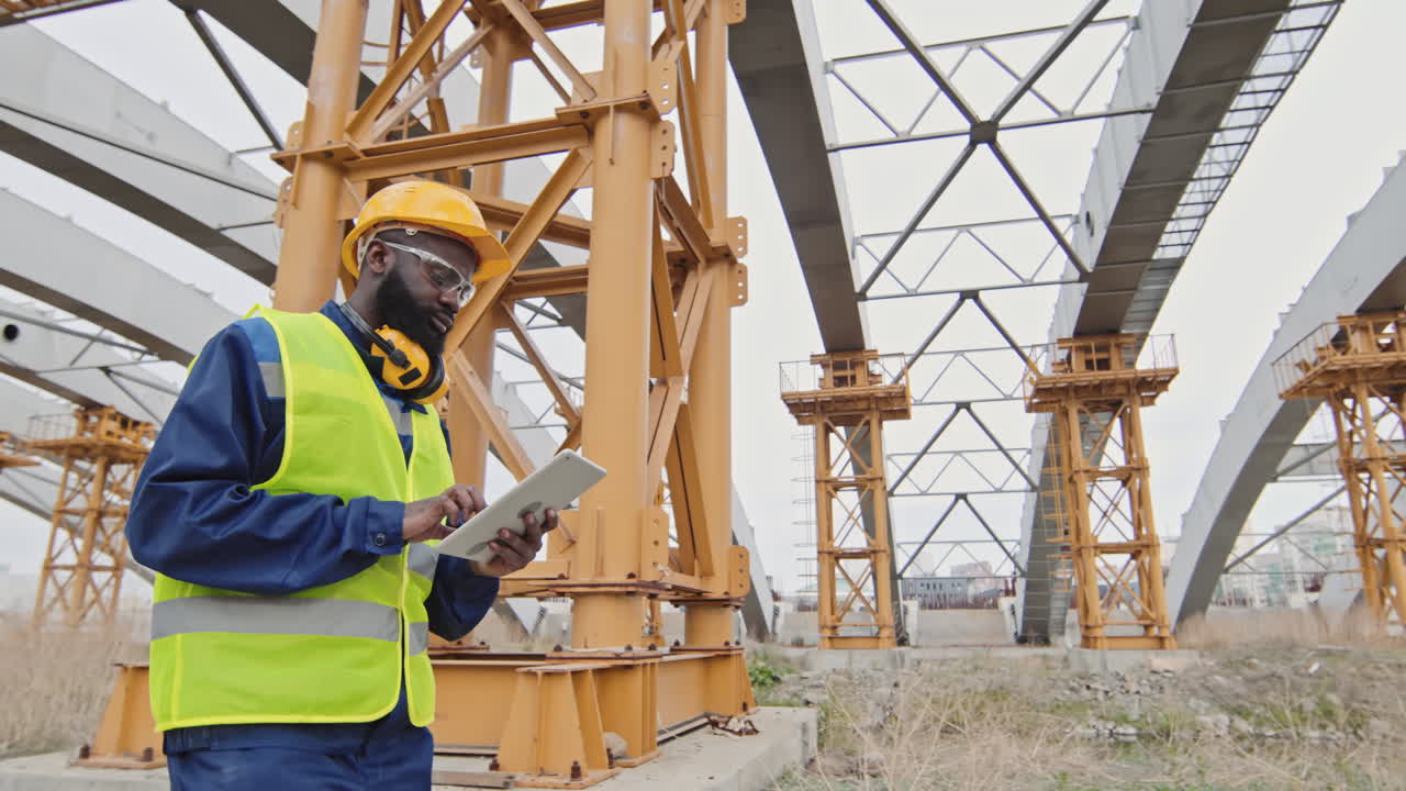 African-American Construction Supervisor Inspecting Site