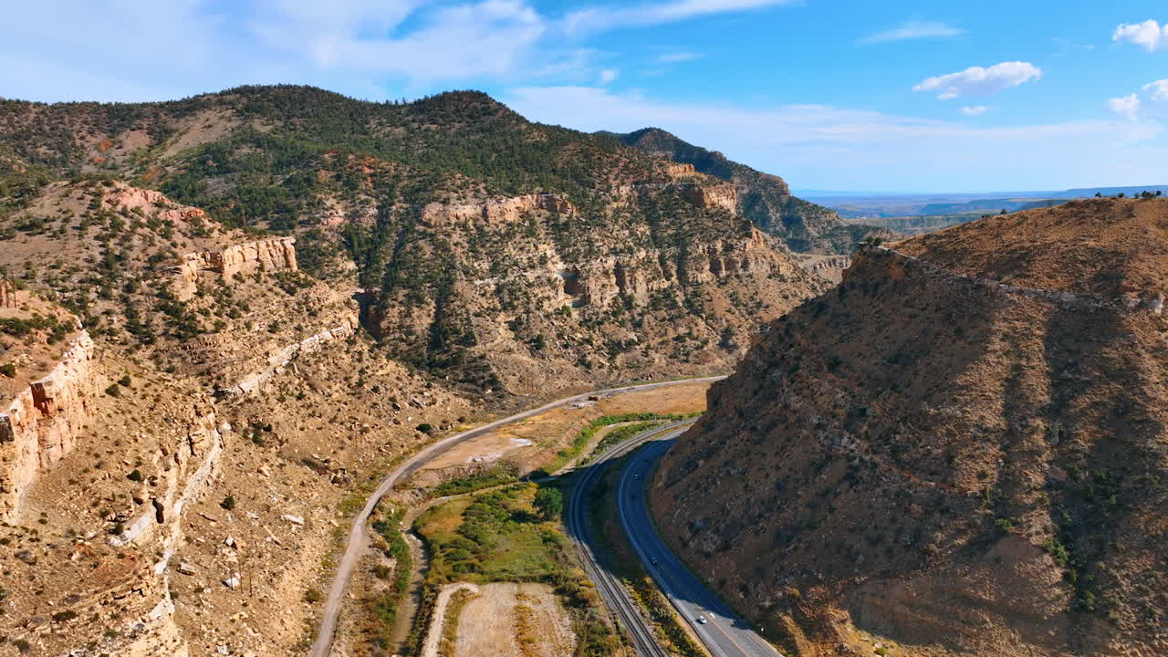 Aerial photo of Price Canyon showing the steep cliffs and winding roads surrounded by rugged desert mountains in Utah