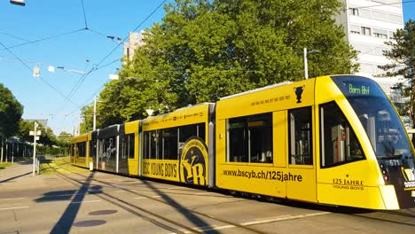 yellow tram with bsc young boys advertisement