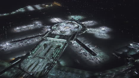 aerial view of a large airport hub at night