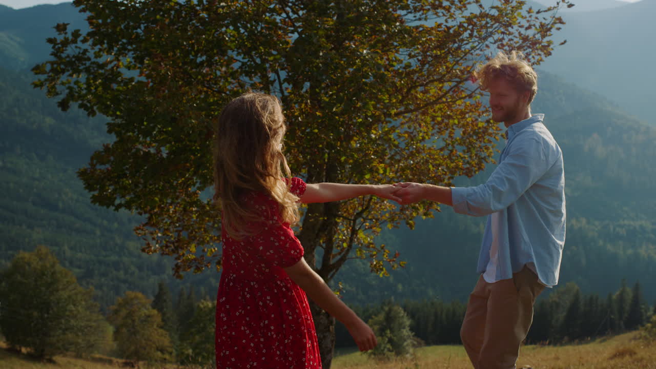 танцующие влюбленные обнимаются на открытом воздухе. веселая семья наслаждается объятием вместе в горах