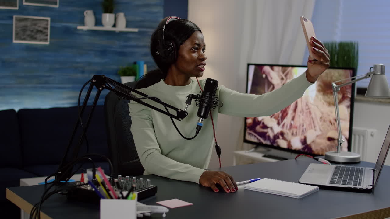 Influencer doing vlog production with professional smartphone in home studio