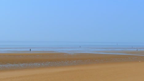 camera pan right to left vast wide open empty beach blue sky and ocean